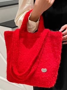 Plush red faux fur tote bag with heart logo, stylish crossbody and handheld shoulder bag