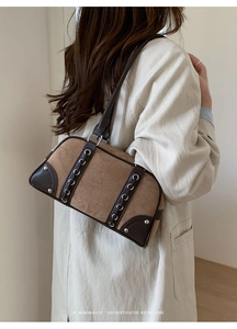 Detailed side view of vintage shoulder bag with brown leather and beige suede textures