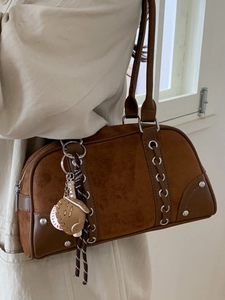 Vintage brown bowling bag with suede texture, side lacing details and baseball pendant
