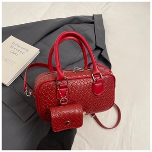 Detail of red woven texture Boston bag with detachable strap and matching mini pouch