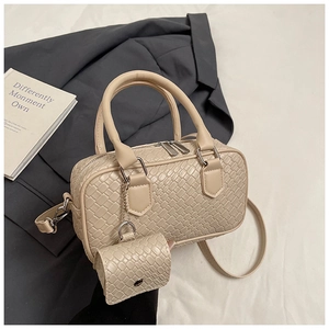 Detail view of beige woven texture Boston bag with mini pouch and leather handles