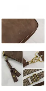 Close-up of retro shell bag featuring golden hardware and woven patterned shoulder strap