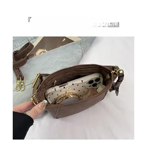 Internal view of the brown shell crossbody bag showing large capacity and zipper pocket