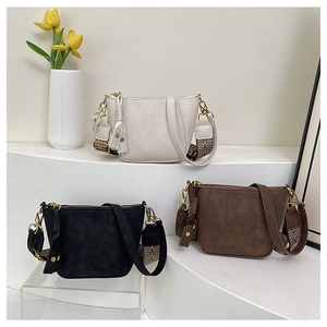 Three leather shell bags in beige, black and brown with bohemian woven shoulder straps