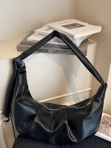 Large vintage black pleated faux leather hobo bag with knotted shoulder strap and metal ring
