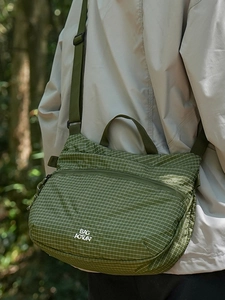 Green checkered crossbody bag with adjustable strap for casual outdoor activities