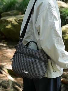Minimalist black checkered nylon crossbody bag with adjustable strap and large capacity