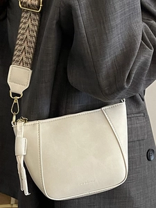 Minimalist white leather shell bag with wide geometric strap and contrast stitching