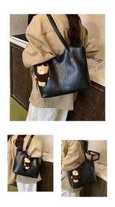 Detailed views of a large black tote bag with vintage leather texture and bear charm