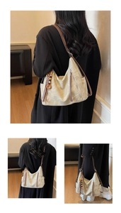Detail of a large hobo bag featuring vintage cream leather and a beaded tassel charm