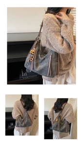 Detail of vintage gray tote bag with long leather tassels and wooden bead charm