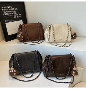Collection of four large casual tote bags in earthy tones with metal chain straps