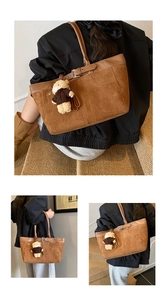Detailed view of dark brown suede tote bag featuring a cute plush bear charm and leather strap