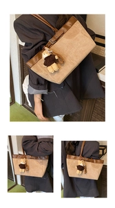 Detail of khaki tote bag with dark brown leather straps and cute bear pendant
