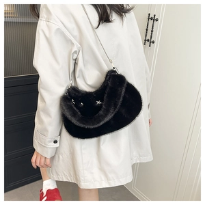 Détail du sac croissant en fausse fourrure noire avec clous étoiles et chaîne argentée