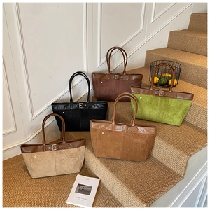 Detail of five vintage-style tote bags in khaki and caramel colors on a carpeted step