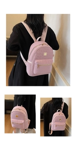 Detailed macro view of pink leopard embossed texture and golden zippers on mini backpack