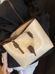 Retro cream leather tote bag with brown trim and elephant charm for daily commuting