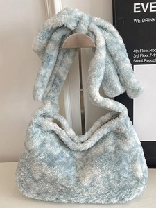 Blue and white tie-dye plush bucket bag for women featuring a wide shoulder strap