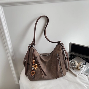 Detail of vintage brown tote bag with retro washed texture and dual zipper accents