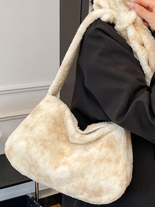 Fashionable beige plush bucket tote bag with wide strap and matching fuzzy scarf accent
