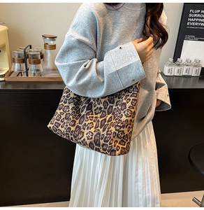 Detailed view of a leopard print canvas tote bag styled with casual fall outfits