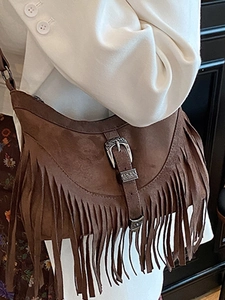Vintage brown suede fringe crossbody bag with retro metal buckle and bohemian tassel details