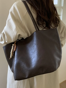Classic deep brown tote bag with vintage texture and stylish beaded tassel decoration
