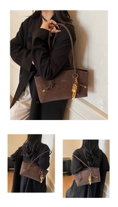 Close-up of deep brown suede tote bag featuring bohemian beaded charm and letter print
