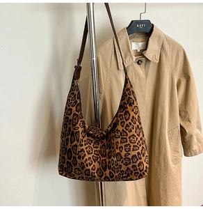Detail showing the adjustable leather strap and leopard print texture on this large hobo tote