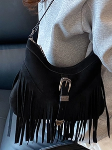 Vintage black fringe crossbody bag with retro engraved metal buckle and matte suede texture