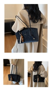Three-view display of black marble texture tote bag with wooden bead charm and gold logo