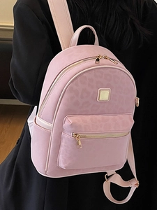 Pink leopard print mini backpack for women featuring golden metal hardware and front zip pocket