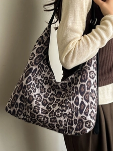 Chic leopard print half-moon tote bag with black leather strap for autumn fashion