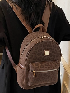 Leopard print backpack with large capacity and brown leather trim for women on travel