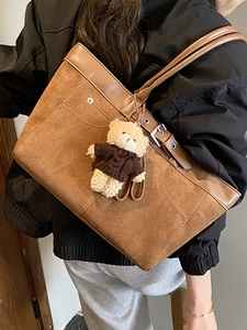 Large brown vintage tote bag with bear charm and chic patchwork design for daily commute