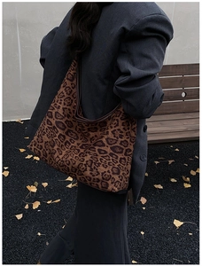 Detailed view of the large leopard print tote bag styled with a dark oversized blazer