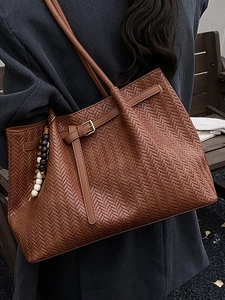 Brown woven leather tote bag with beaded pendant and metal buckle for women