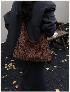 Chic leopard print oversized hobo tote bag styled outdoors on a park bench