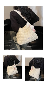 Detailed back view of a beige quilted dumpling bag with a cute plush bunny pendant