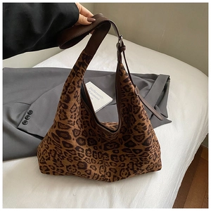 Detail of leopard print tote bag showing velvet texture and brown adjustable strap