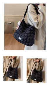 Detail of black quilted cloud tote bag featuring a plush bunny charm and Mulaidi logo