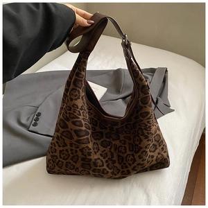 Detailed macro of the leopard print suede hobo bag with a wide adjustable shoulder strap