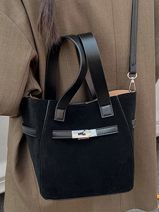 Chic black soft leather bucket bag for women with silver lock and shoulder strap details