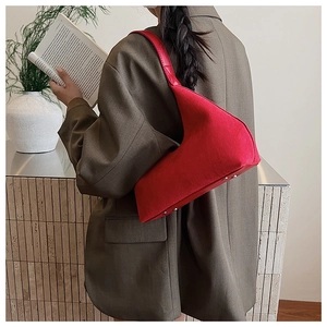 Chic red hobo shoulder bag styled with a grey blazer for a modern casual aesthetic