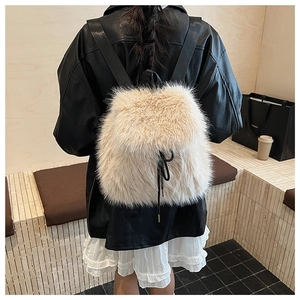 Détail de la texture en fausse fourrure beige sur sac à dos avec cordon noir