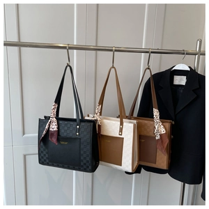 Three elegant tote bags in black, beige, and brown featuring woven checkerboard side details
