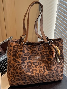 Vintage leopard print suede tote bag with leather handles and decorative wooden beads