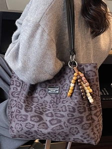 Vintage leopard print suede tote bag in purple with wooden bead charm and black straps