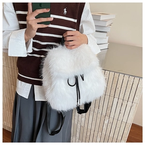 Gros plan d'un sac à dos blanc en fausse fourrure avec cordon de serrage noir